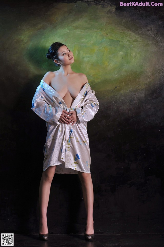 A woman in a white dress posing for a picture.