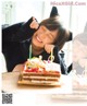 A little girl sitting at a table with a birthday cake.